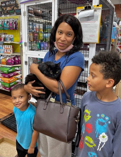 Elsie, the beautiful black cat, with her new family.