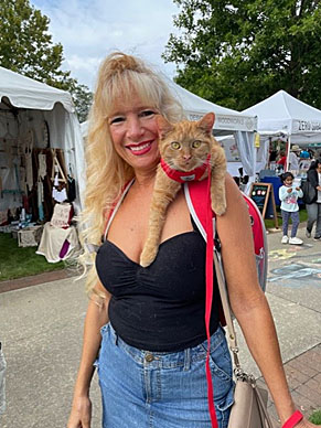 Orange cat on woman's shoulder